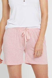 A model wearing the Bamboo Shorts in colour Rose (Pink), from the front, cropped image