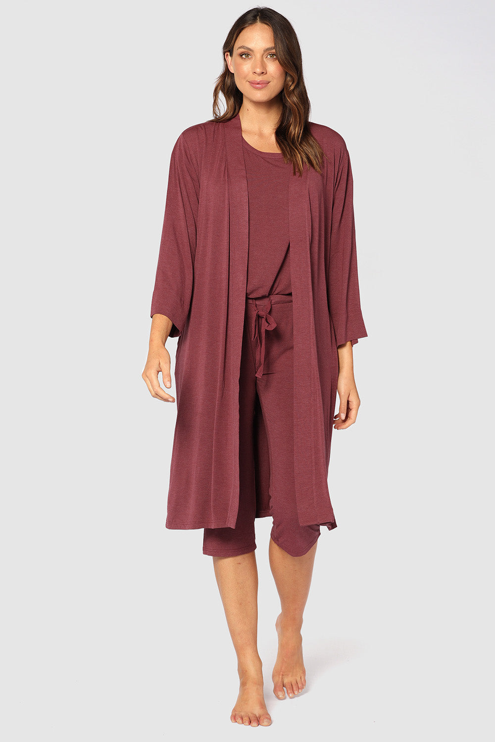 A model wearing the Bamboo Robe in colour Burgundy (Red), from the front, showing the whole outfit