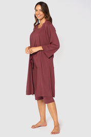 A model wearing the Bamboo Robe in colour Burgundy (Red), from the front, showing the whole outfit