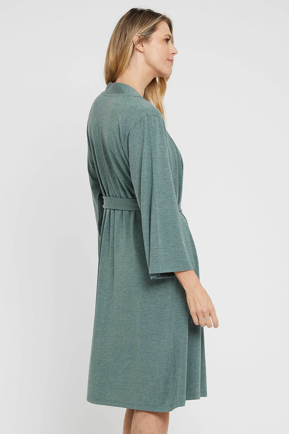 A model wearing the Bamboo Robe in colour Moss (Green), from the back