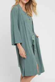 A model wearing the Bamboo Robe in colour Moss (Green), from the front, cropped image