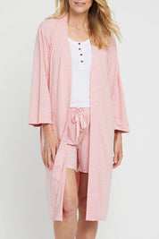A model wearing the Bamboo Robe in colour Rose (Pink), from the front, cropped image