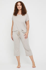 A model wearing the Lounge Bamboo Tee in colour Oatmeal, from the front, showing the whole outfit