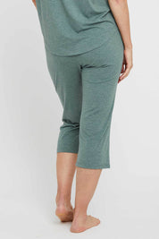 A model wearing the 3/4 Bamboo PJ Pant in colour Moss (Green), from the back