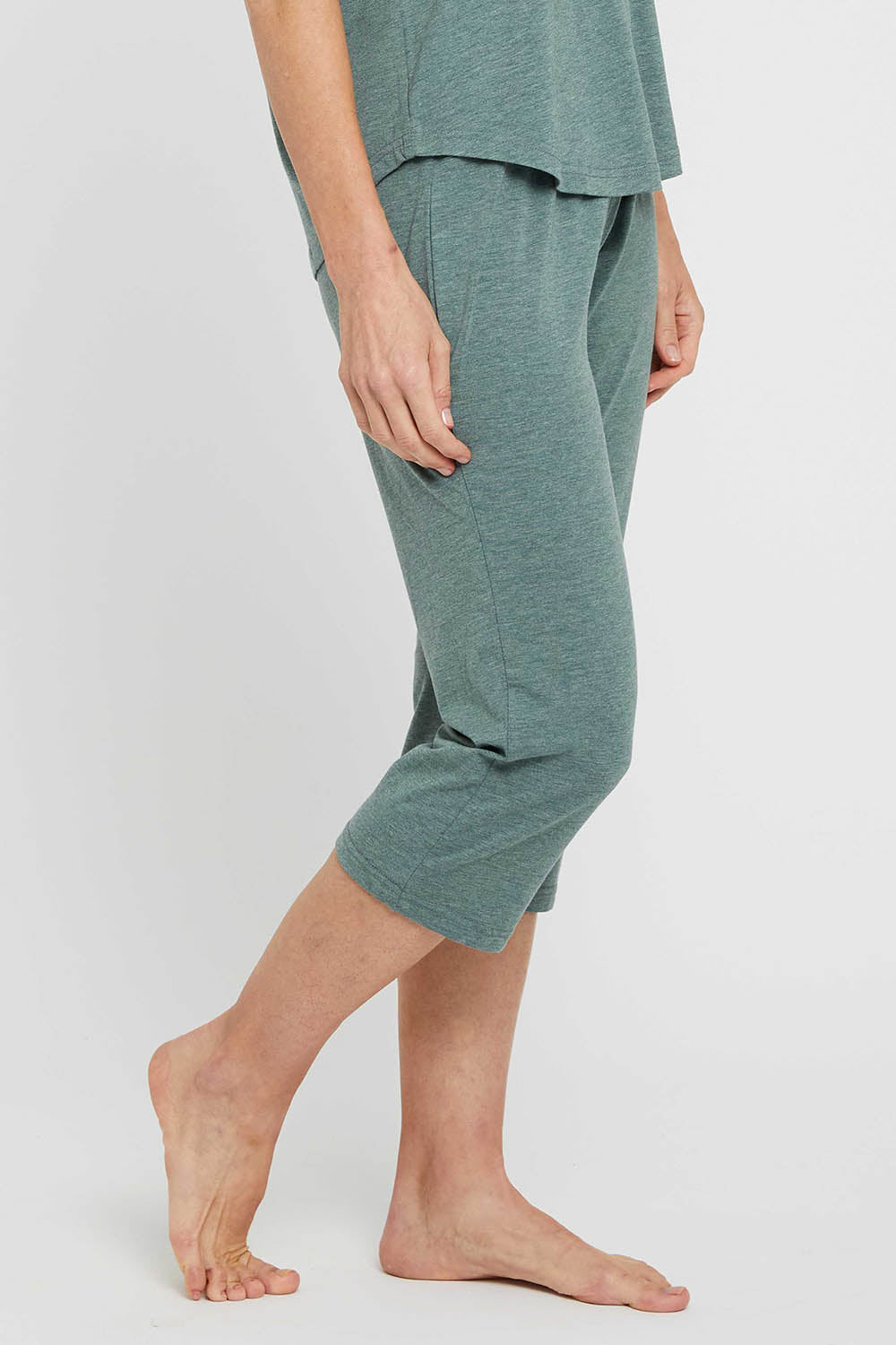 A model wearing the 3/4 Bamboo PJ Pant in colour Moss (Green), from the front, cropped image