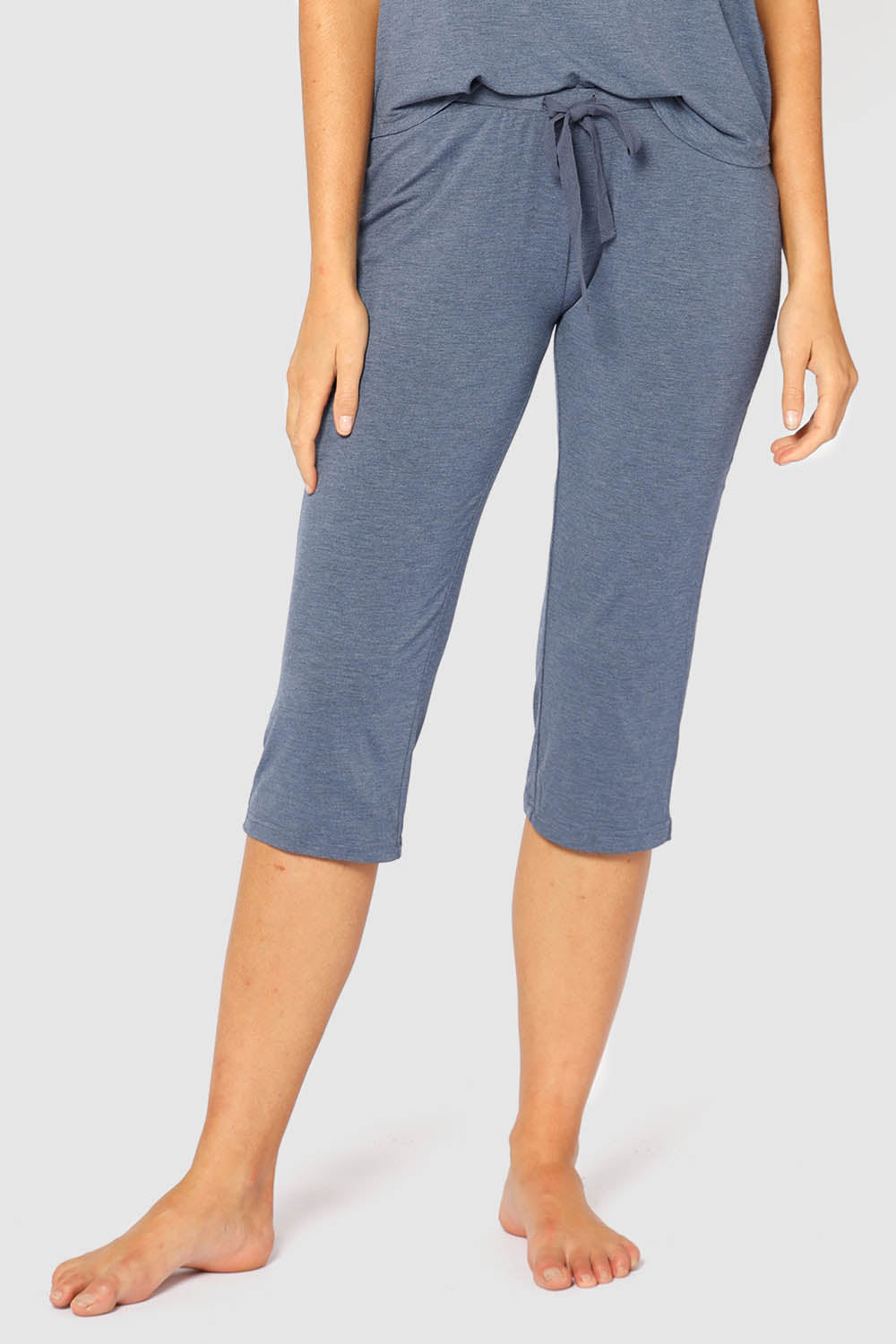 A model wearing the 3/4 Bamboo PJ Pant in colour Twilight (Blue), from the front, cropped image