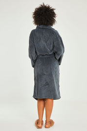 Model Olivia wearing the Microplush Bath Robe in colour Charcoal (Grey), from the back