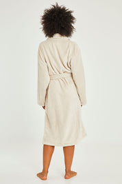 Model Olivia wearing the Microplush Bath Robe in colour Stone, from the back