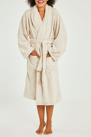 Model Olivia wearing the Microplush Bath Robe in colour Stone, from the front, cropped image