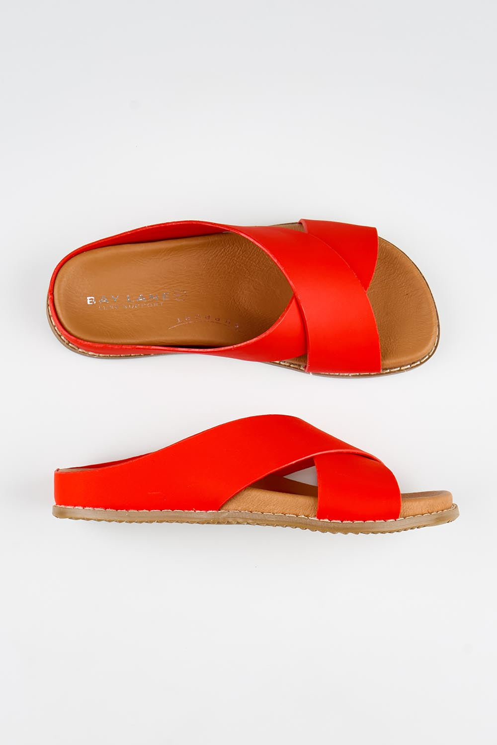 Model Genericm wearing size sample of the Mystic Leather Slide - Coral in colour Coral, from an angle