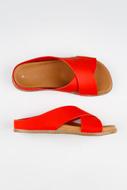 Model Genericm wearing size sample of the Mystic Leather Slide - Coral in colour Coral, from an angle