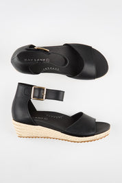Model Genericm wearing size sample of the Olivia Espadrille Heel - Black in colour Black, from an angle