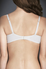 A model wearing the Barely There tin colourshirt  Bra - Ivory (White), from the back