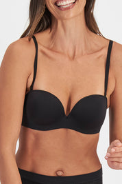 A model wearing the Strapless Bra in colour Black (Black), from the front, cropped image