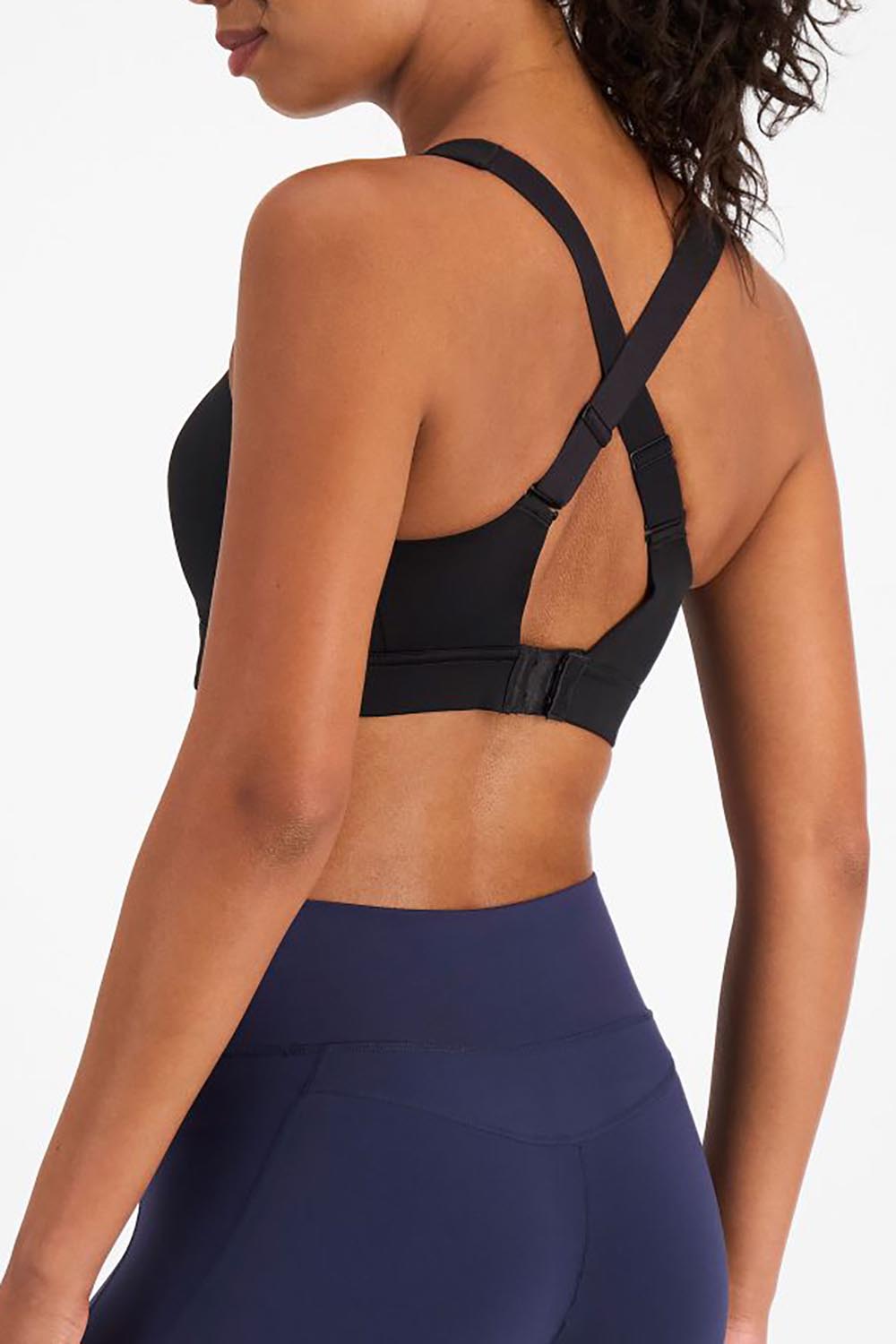 A model wearing the Smooth Power Wirefree Sports Bra in colour Black (Black), from the back