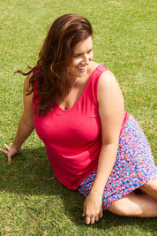 A model wearing the Sirena Reversible Tank in colour Rosered (Red), from the front, showing the whole outfit