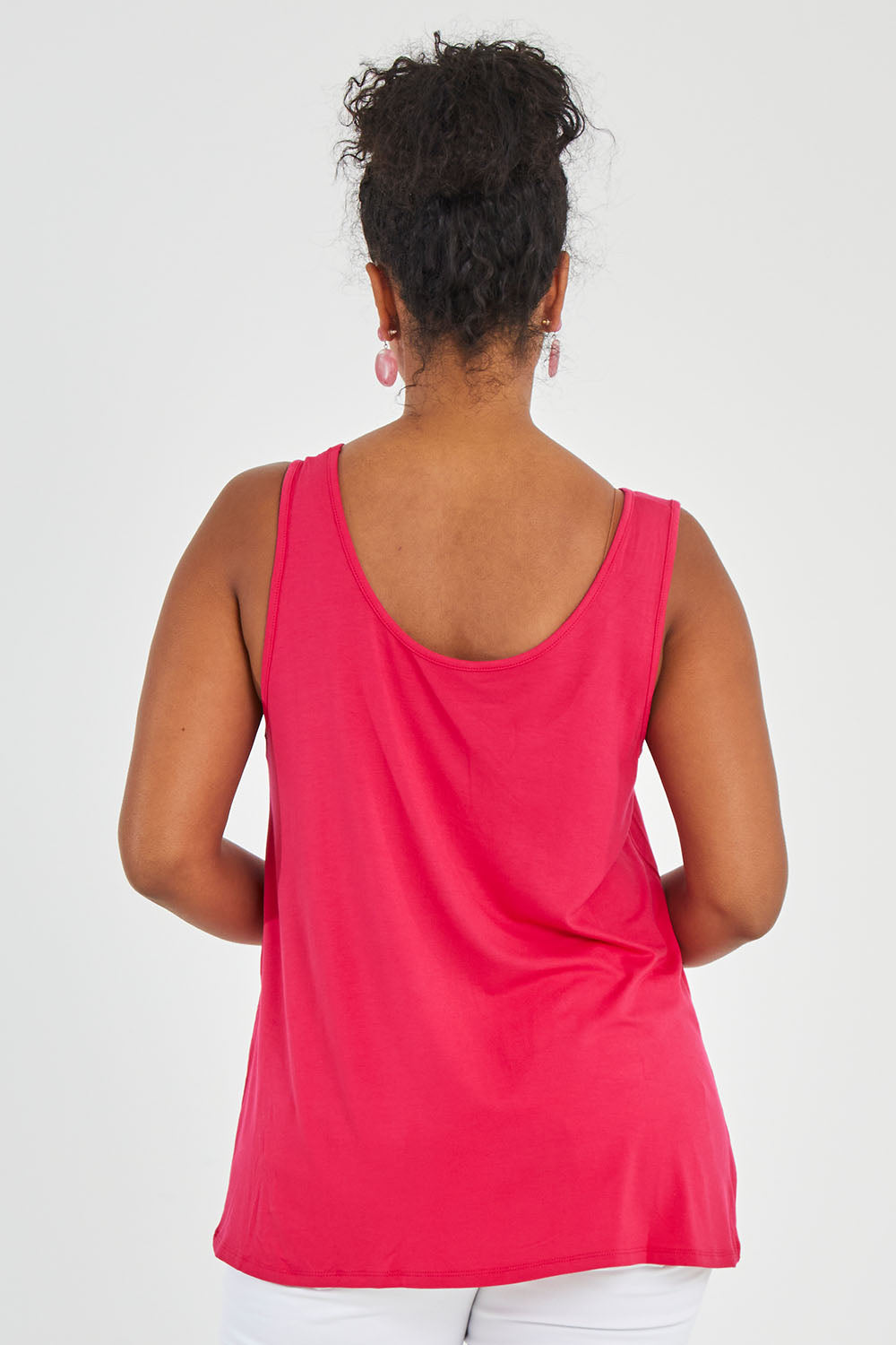 Model Noli wearing size 14 of the Sirena Reversible Tank in colour Rosered (Red), from the back