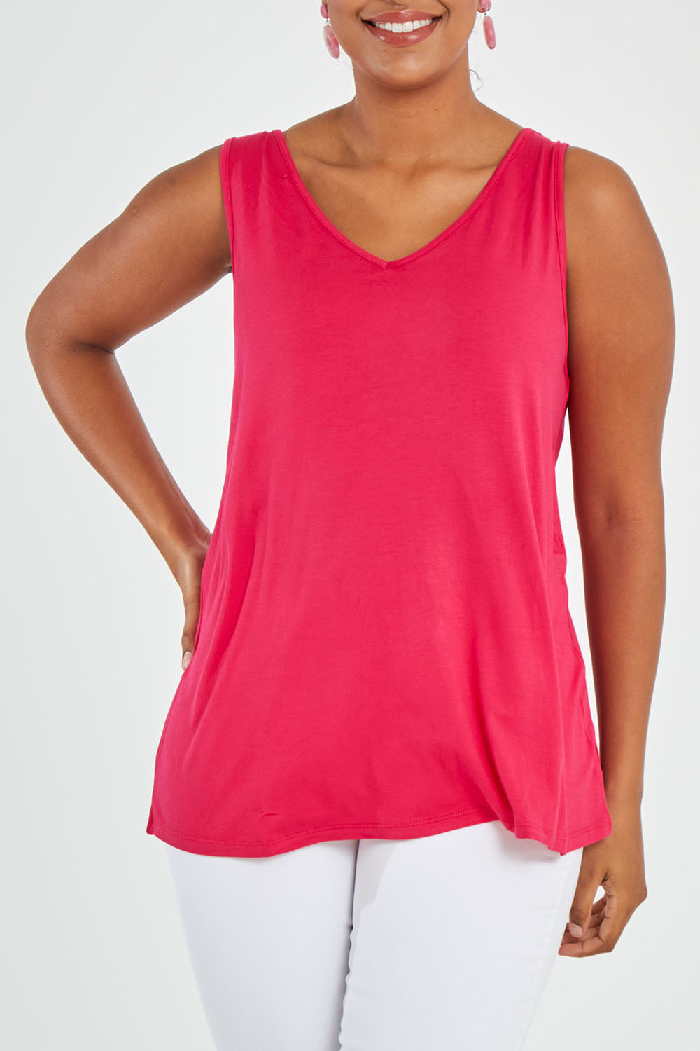 Model Noli wearing size 14 of the Sirena Reversible Tank in colour Rosered (Red), from the front, cropped image