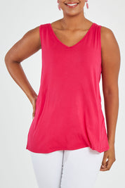 Model Noli wearing size 14 of the Sirena Reversible Tank in colour Rosered (Red), from the front, cropped image