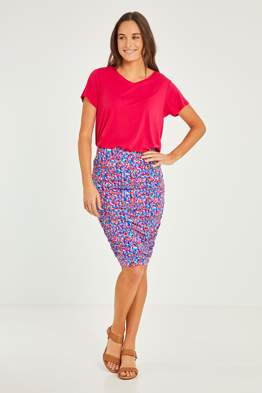 Model Elhana wearing size 10 of the Nadia Skirt in colour Paradise (Blue), from the front, showing the whole outfit