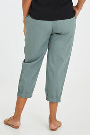 Model Noli wearing size 14 of the Lennon Pant in colour Deepgrn (Green), from the back