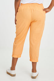 Model Noli wearing size 14 of the Lennon Pant in colour Mango, from the back