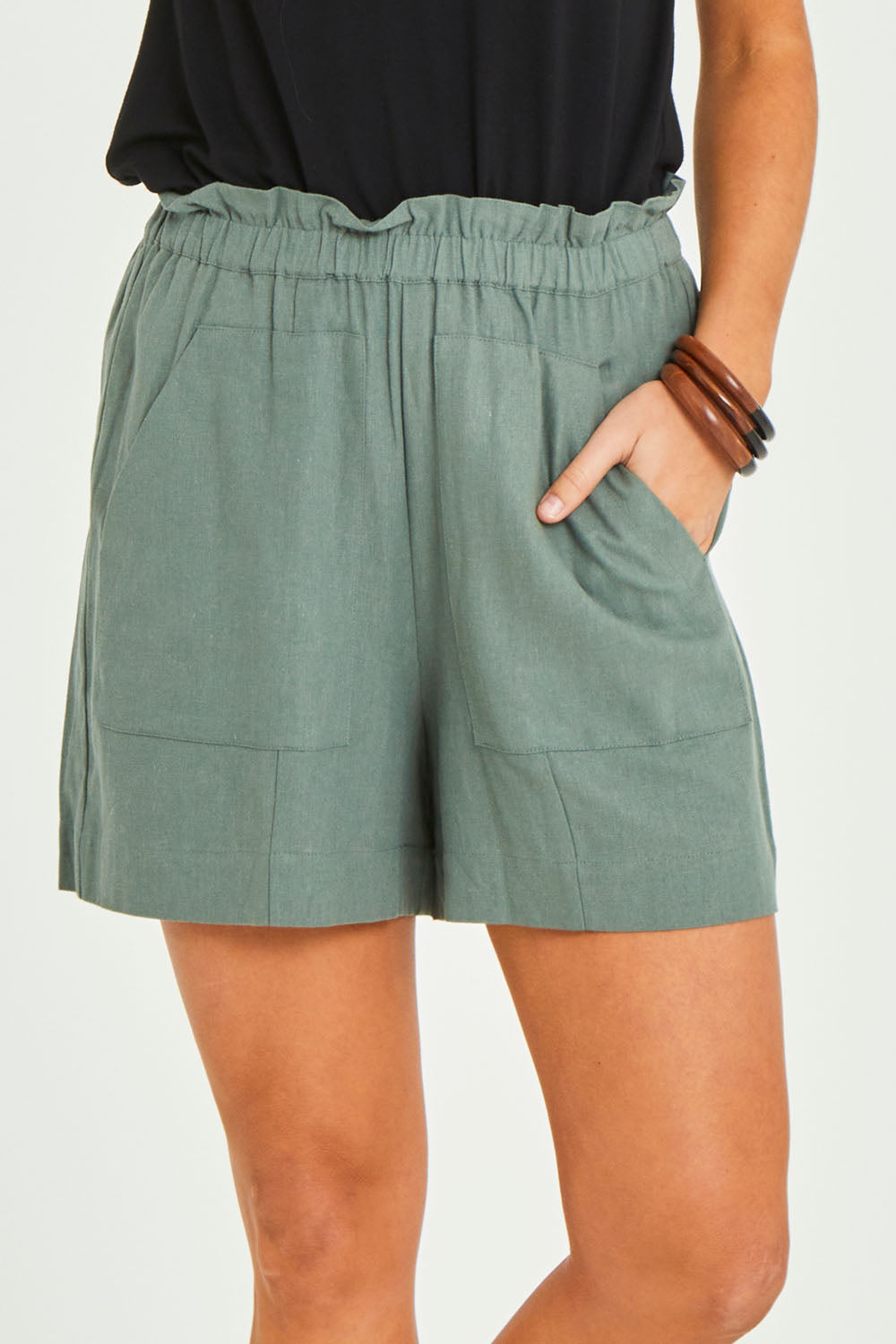 Model Elhana wearing size 10 of the Baker Short in colour Deepgrn (Green), from the front, cropped image