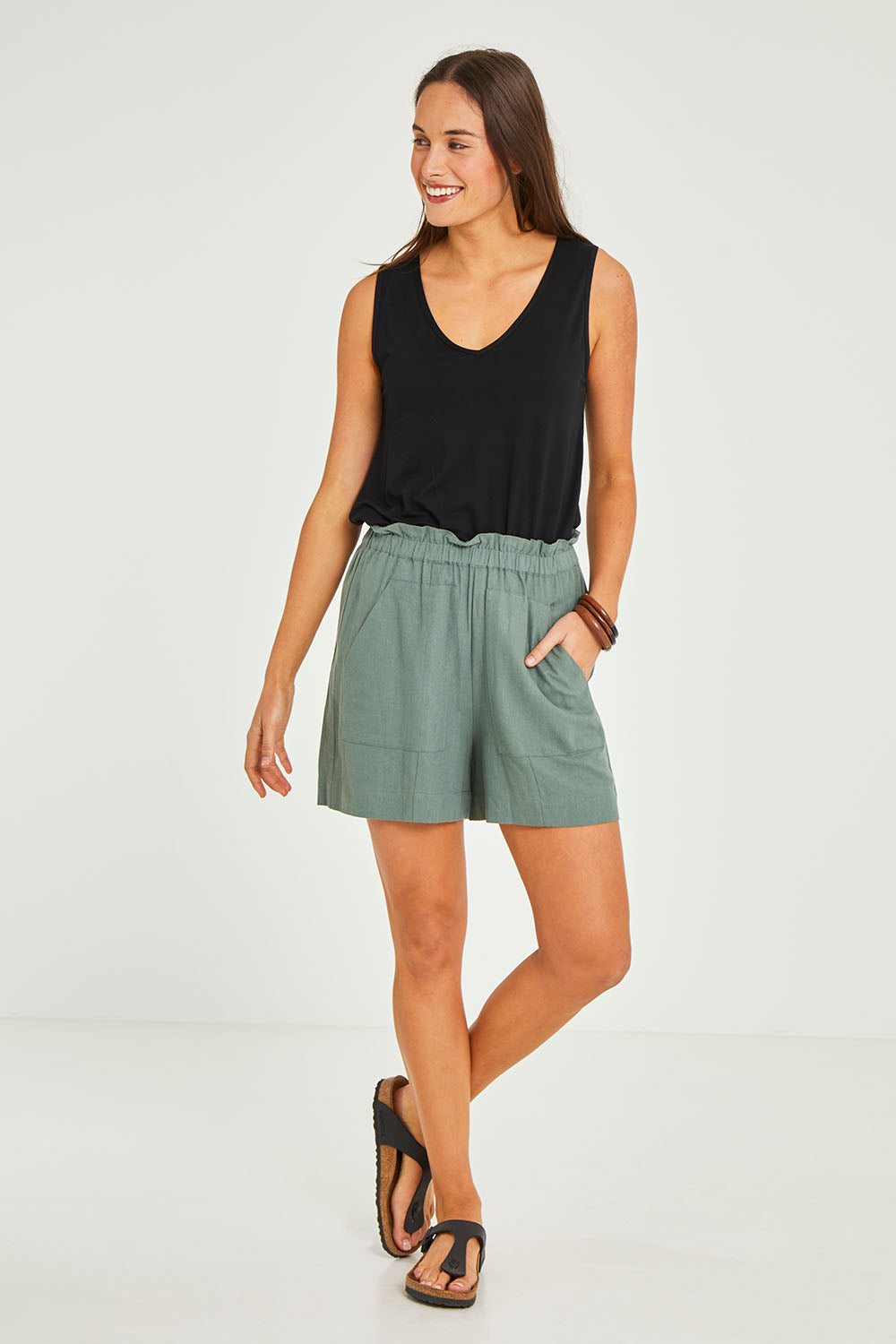 Model Elhana wearing size 10 of the Baker Short in colour Deepgrn (Green), from the front, showing the whole outfit