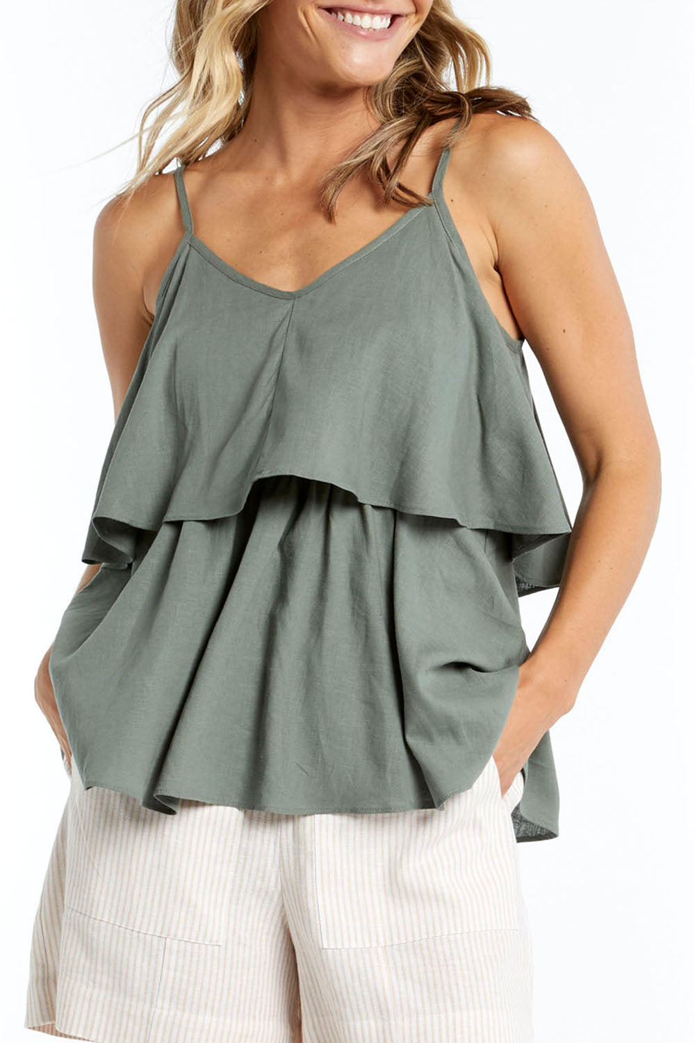 A model wearing the Fifi Cami in colour Deepgrn (Green), from the front, cropped image
