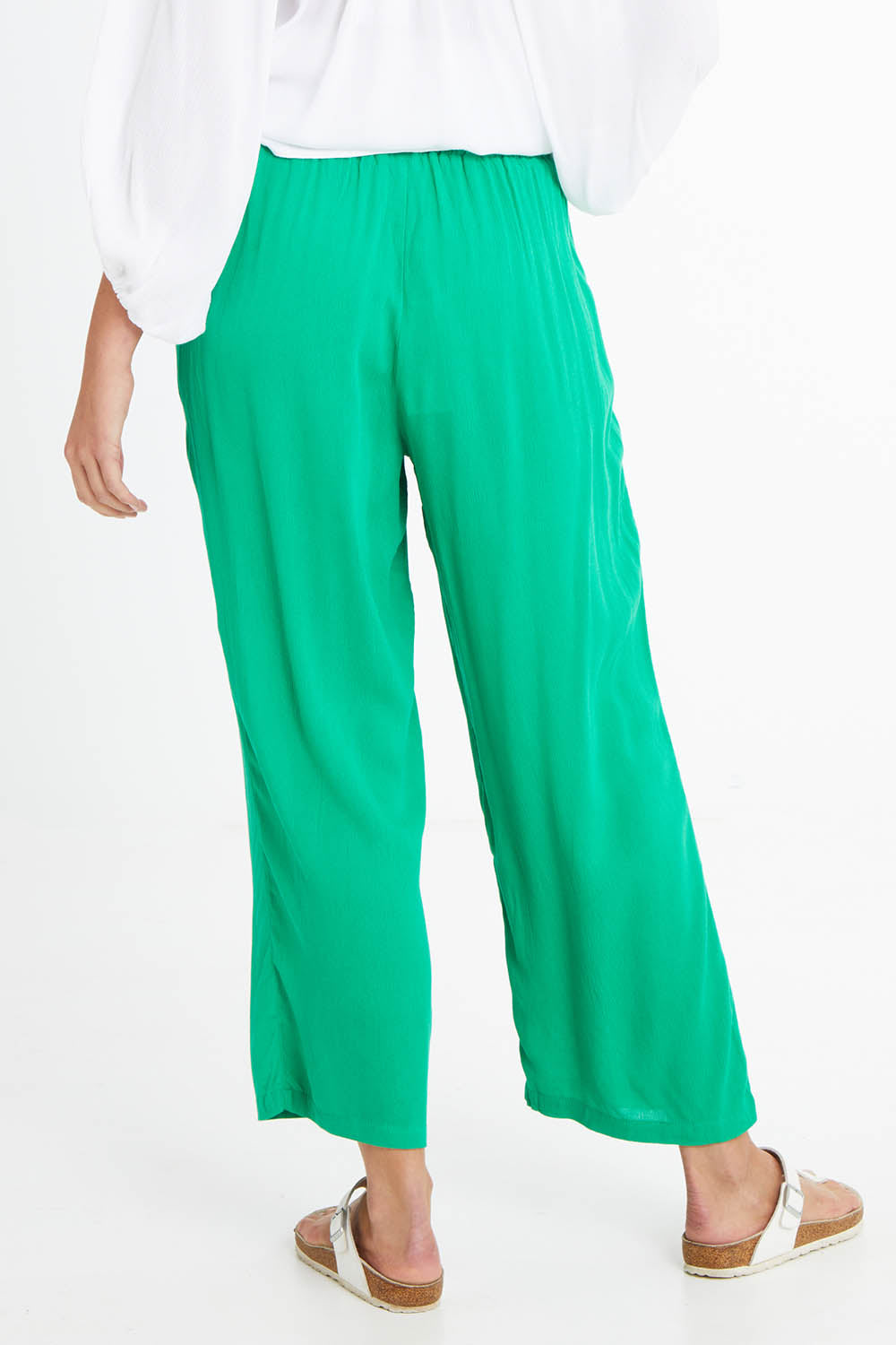Model Madeline wearing size 10 of the Rani Pants in colour Green (Green), from the back