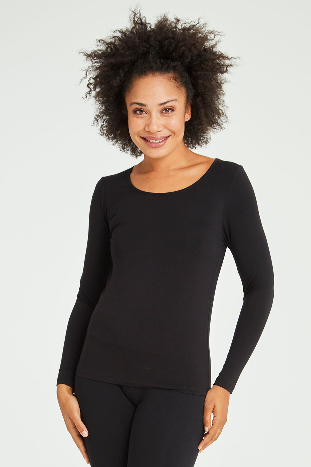 Model Olivia wearing size 10 of the Kelli Long Sleeve Top in colour Black (Black), from the front, cropped image