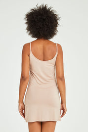 Model Olivia wearing size 10 of the Roxie Reversible Slip in colour Nude, from the back