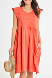 Model Madeline wearing size 10 of the Frill Dress in colour Clay, from the front, cropped image