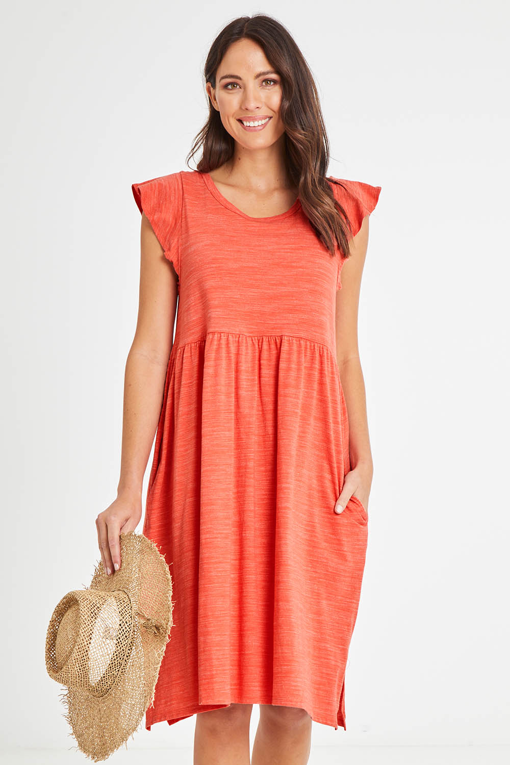 Model Madeline wearing size 10 of the Frill Dress in colour Clay, from the front, cropped image