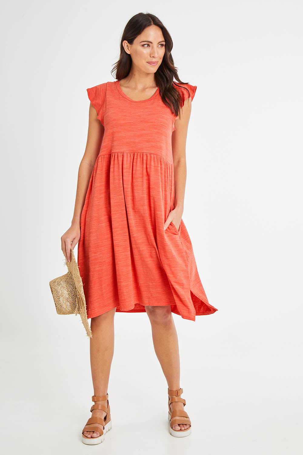 Model Madeline wearing size 10 of the Frill Dress in colour Clay, from the front, showing the whole outfit