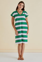A model wearing the Zena Cotton Tin colourShirt Dress - Green (Green), from the front, showing the whole outfit