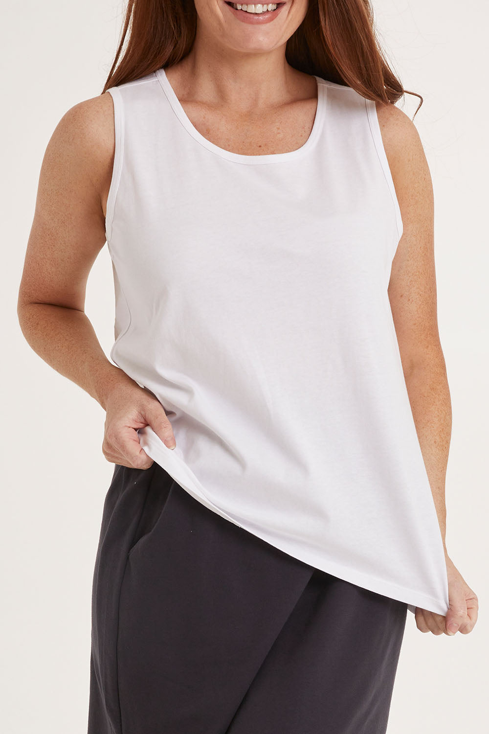 Model Sally wearing size 10 of the Josie Tank in colour White (White), from the front, cropped image