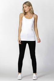 A model wearing the Vivienne Singlet in colour White (White), from the front, showing the whole outfit