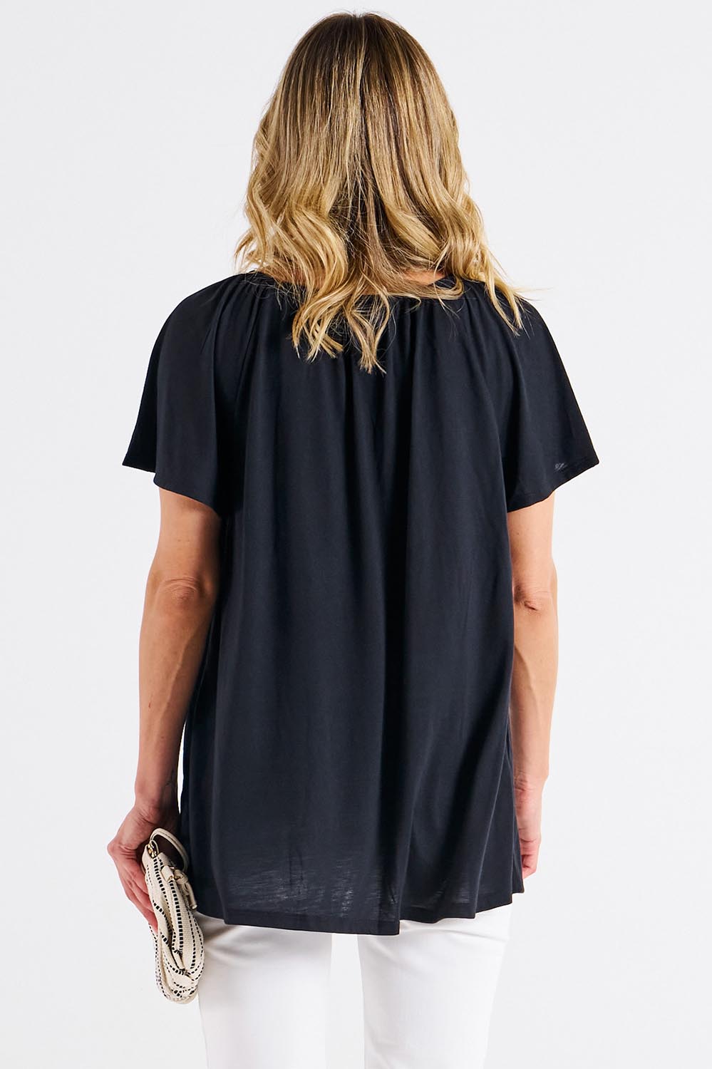 A model wearing the Coral Bamboo Shirred Tee in colour Black (Black), from the back