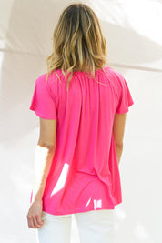 A model wearing the Coral Bamboo Shirred Tee in colour Pink (Pink), from the back
