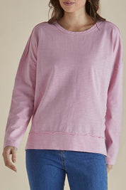 A model wearing the Roxette Cotton Tee in colour Pink (Pink), from the front, cropped image