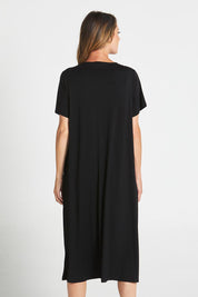 A model wearing the Irena Bamboo Tin colourShirt Dress - Black (Black), from the back