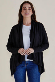 A model wearing the Maeve Bamboo Cardigan in colour Black (Black), from the front, cropped image