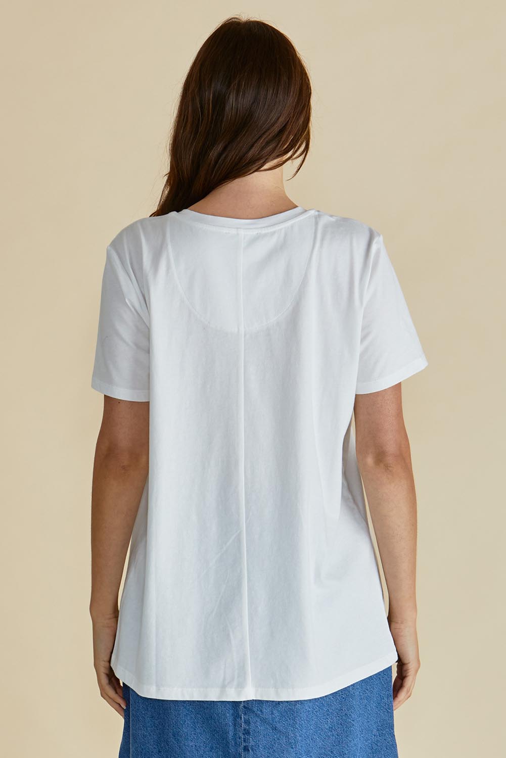 A model wearing the Ellia Cotton Crew Tee in colour Bomdia (White), from the back