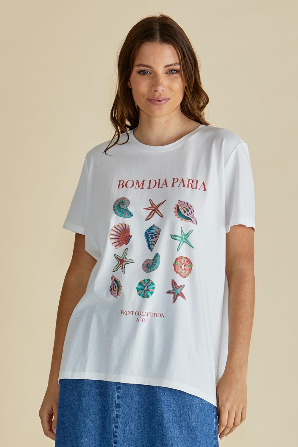 A model wearing the Ellia Cotton Crew Tee in colour Bomdia (White), from the front, cropped image