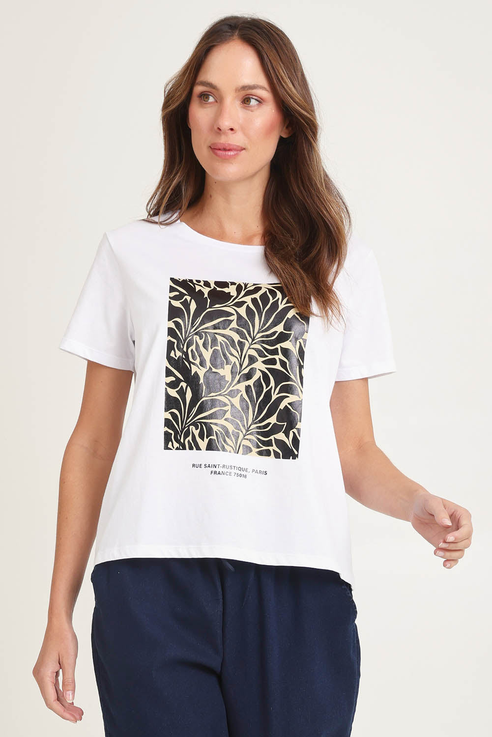 Model Madeline wearing size 10 of the Ellia Cotton Crew Tee in colour Floral (White), from the front, cropped image