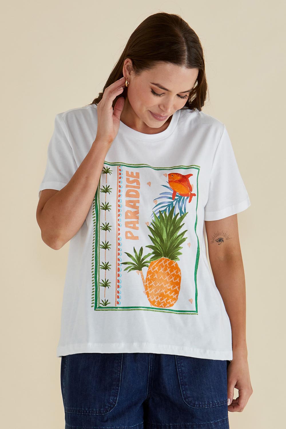 A model wearing the Ellia Cotton Crew Tee in colour Paradise (White), from the front, cropped image