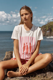 A model wearing the Ellia Cotton Crew Tee in colour Sardinia (White), from the front, showing the whole outfit