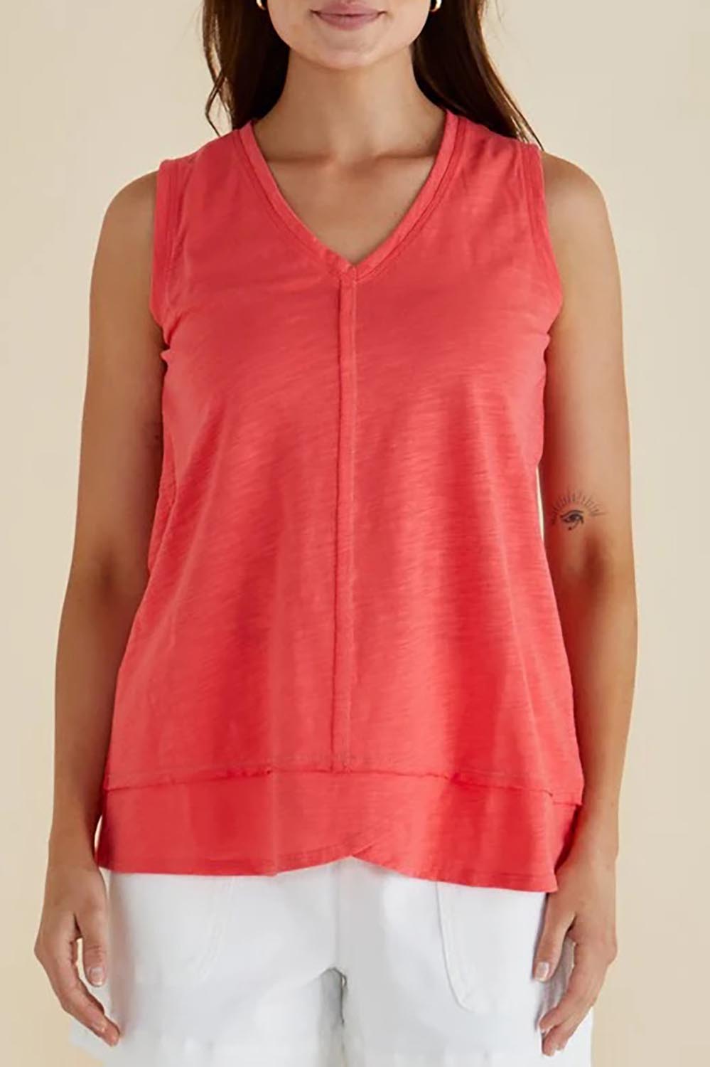 A model wearing the Mariah Cotton Tank in colour Grapefruit (Pink), from the front, cropped image