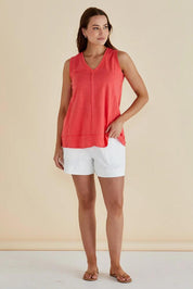 A model wearing the Mariah Cotton Tank in colour Grapefruit (Pink), from the front, showing the whole outfit